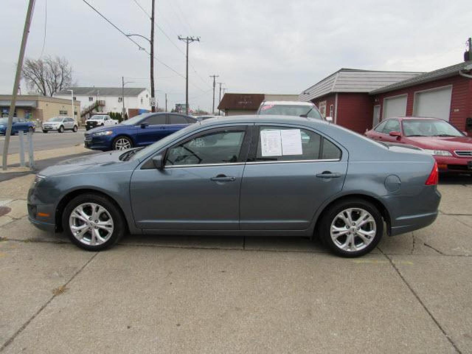 2012 Blue Flame Metallic Ford Fusion SE (3FAHP0HA2CR) with an 2.5 4 Cylinder Sequential Multiport Fuel Injection engine, 6-Speed Automatic transmission, located at 5505 N. Summit St., Toledo, OH, 43611, (419) 729-2688, 41.654953, -83.530014 - Photo #18