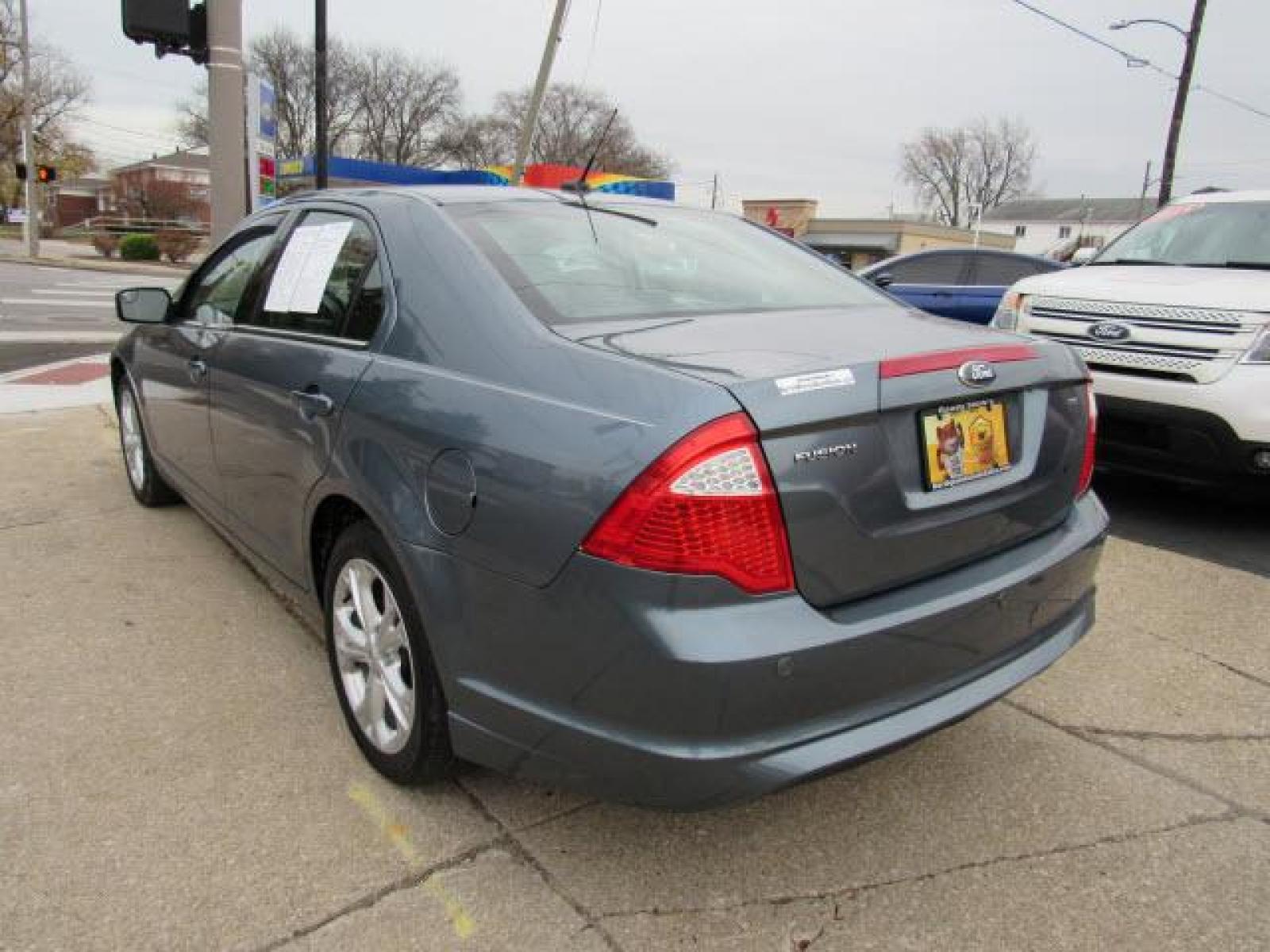 2012 Blue Flame Metallic Ford Fusion SE (3FAHP0HA2CR) with an 2.5 4 Cylinder Sequential Multiport Fuel Injection engine, 6-Speed Automatic transmission, located at 5505 N. Summit St., Toledo, OH, 43611, (419) 729-2688, 41.654953, -83.530014 - Photo #19