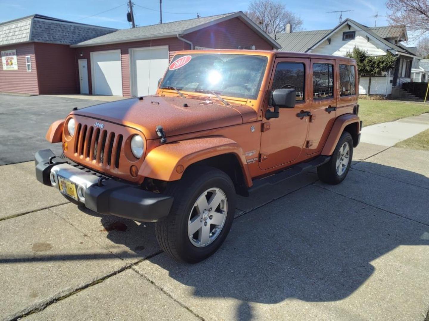 2011 Mango Tango Pearl Coat Pvg Jeep Wrangler Unlimited 4x4 Sahara (1J4BA5H17BL) with an 3.8L 3.8L V6 202hp 237ft. lbs. Sequential Multiport Fuel Injection engine, 4-Speed Automatic transmission, located at 5505 N. Summit St., Toledo, OH, 43611, (419) 729-2688, 41.654953, -83.530014 - Photo#13